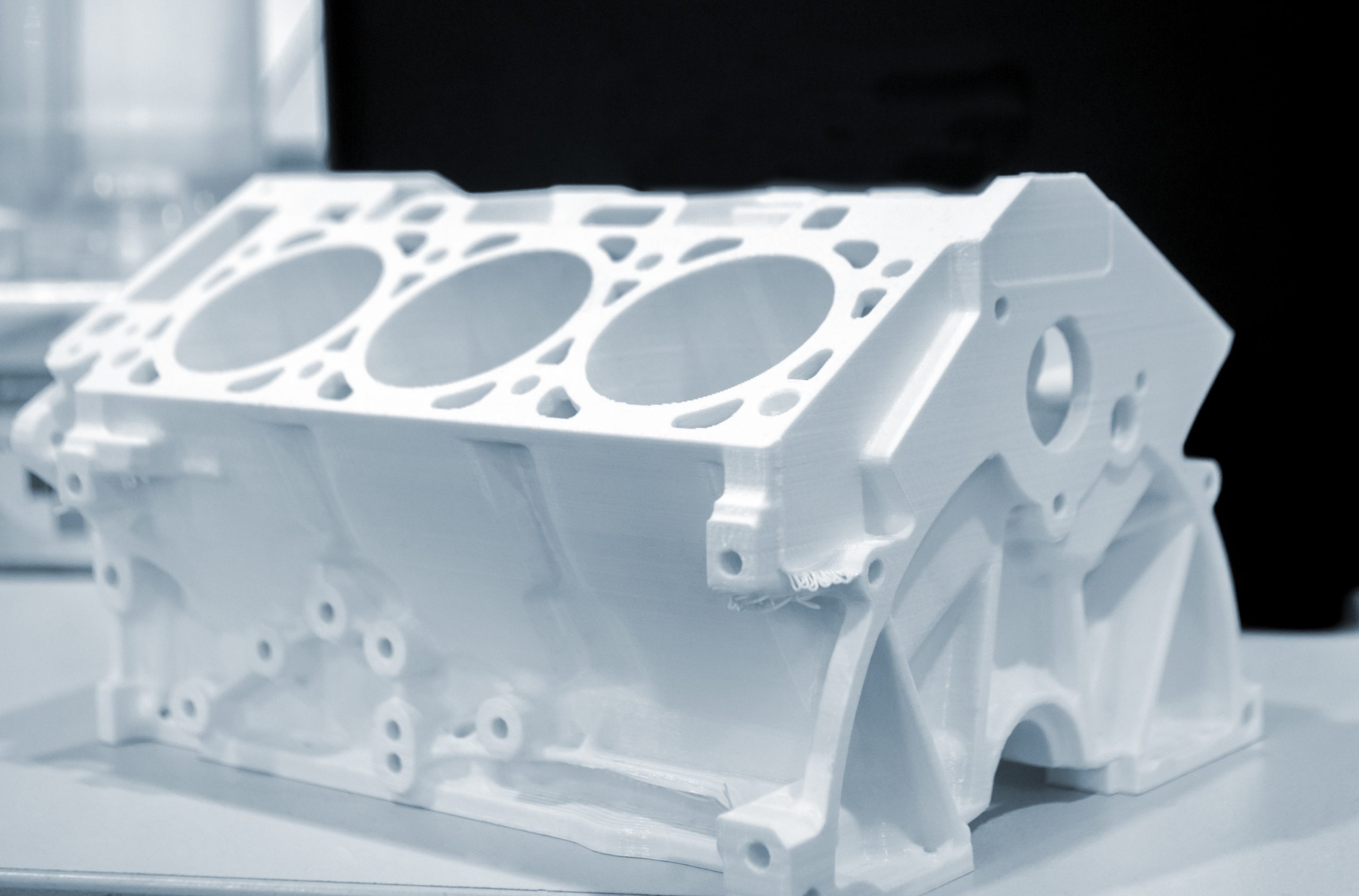 Objects prototype car motor printed on 3d printer from plastic filament close-up. Modern new prototyping technology. Additive automation manufacturing Fused deposition modeling. 3D printing technology